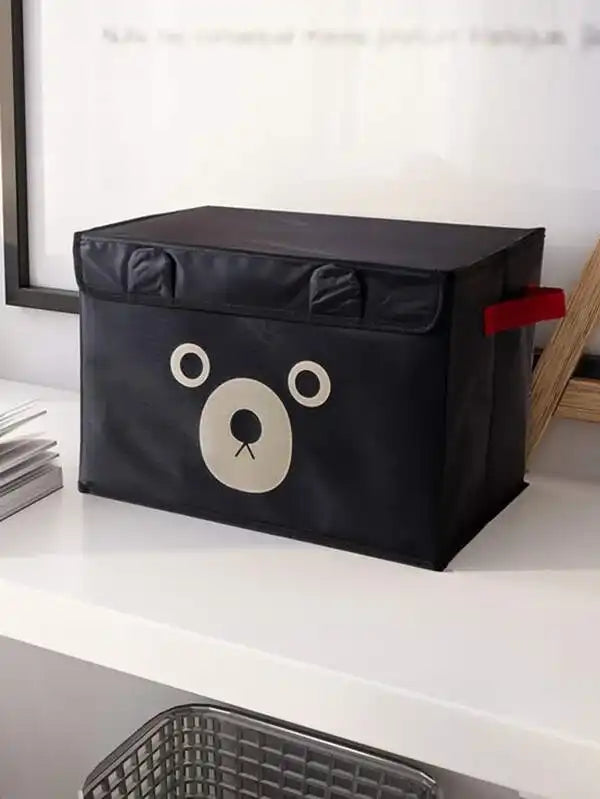 Black storage box with a bear face design on a white surface