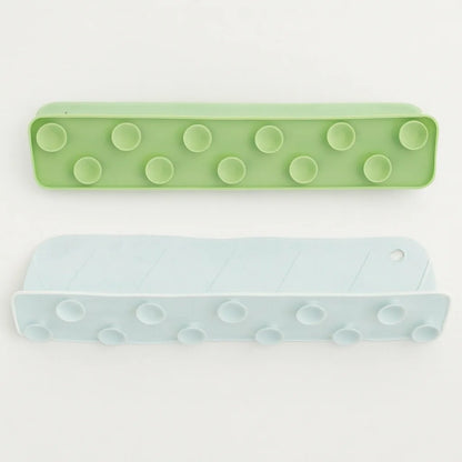 Two green and light blue rectangular objects with circular patterns on a white background