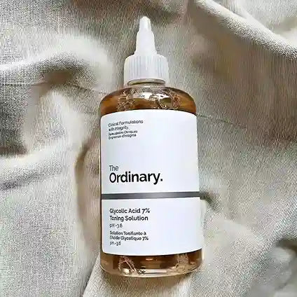 Bottle of 'The Ordinary' Glycolic Acid 7% Toning Solution on a textured fabric background