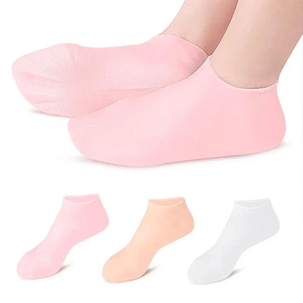 Set of three pairs of pink, peach, and white socks on a white background