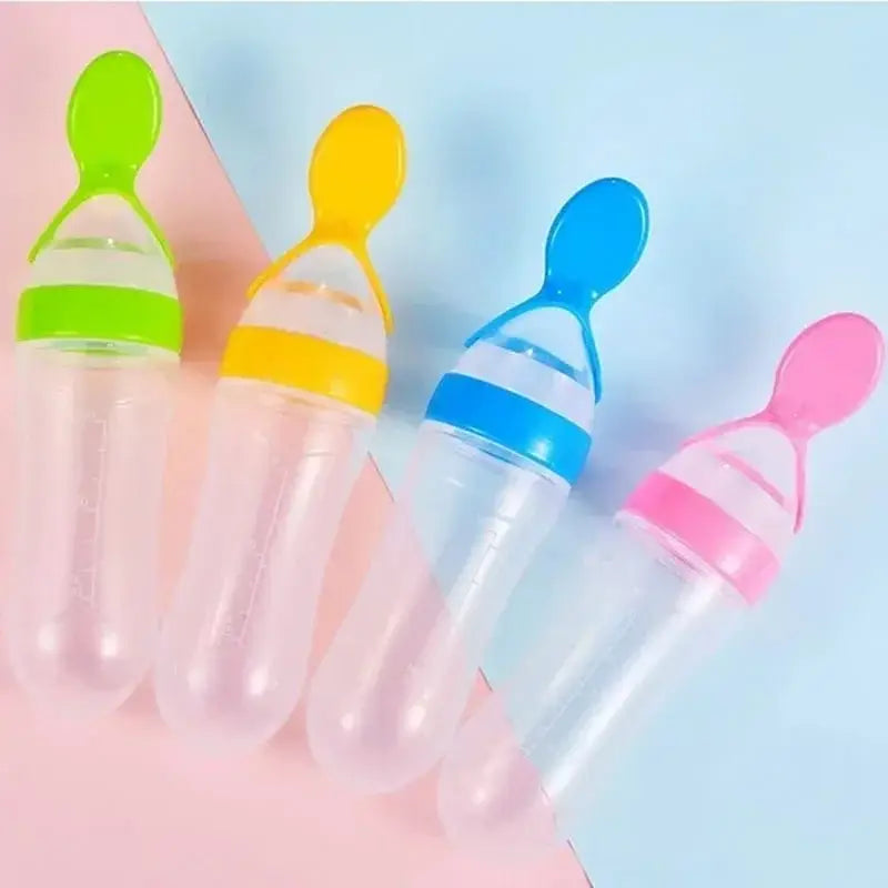 Four colorful baby feeding bottles with silicone spouts on a pink and blue gradient background.