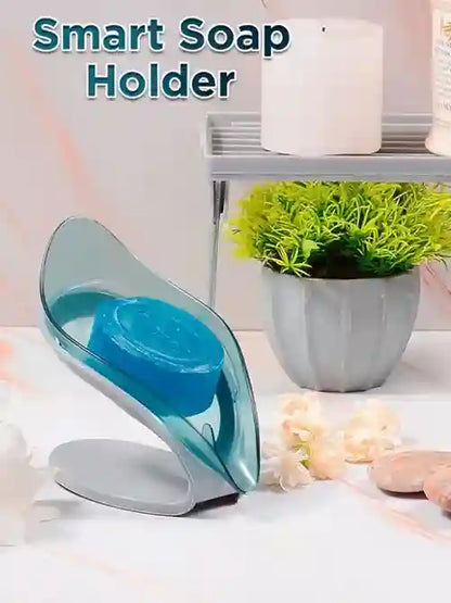 Smart soap holder with blue soap on a white surface with a plant in the background