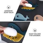 Soap holder shaped like a whale with adhesive surfacing for shower use