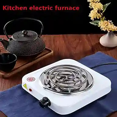 Kitchen electric furnace on a table with a teapot and flowers in the background