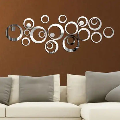 Decorative wall art with circular mirrors on a brown wall above a sofa.