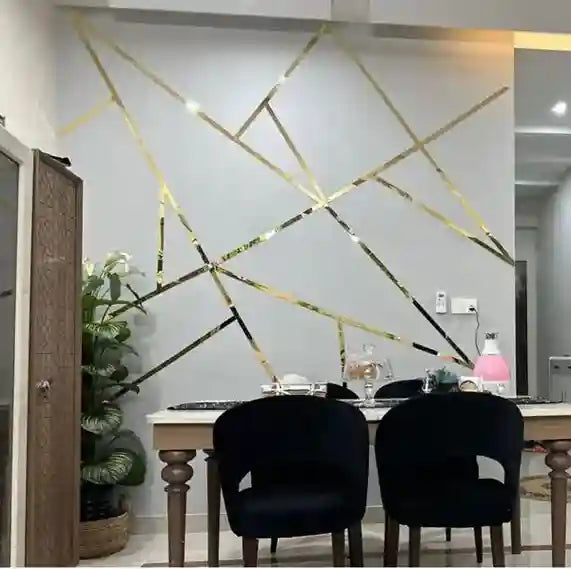 Dining area with geometric wall design, black chairs, and a table.
