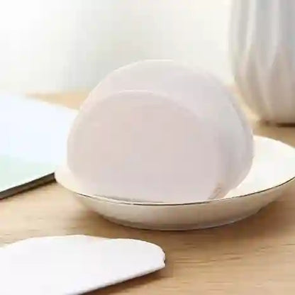 White ceramic bowl with a lid on a wooden surface