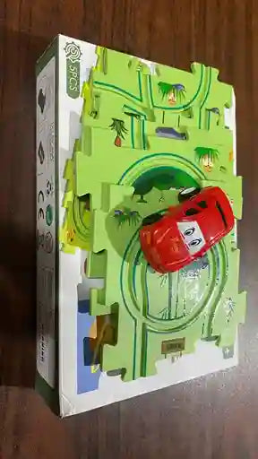 Toy car and packaging with green landscape design on a wooden surface
