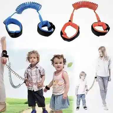 Children wearing blue and orange anti-lost leashes with parents outdoors.