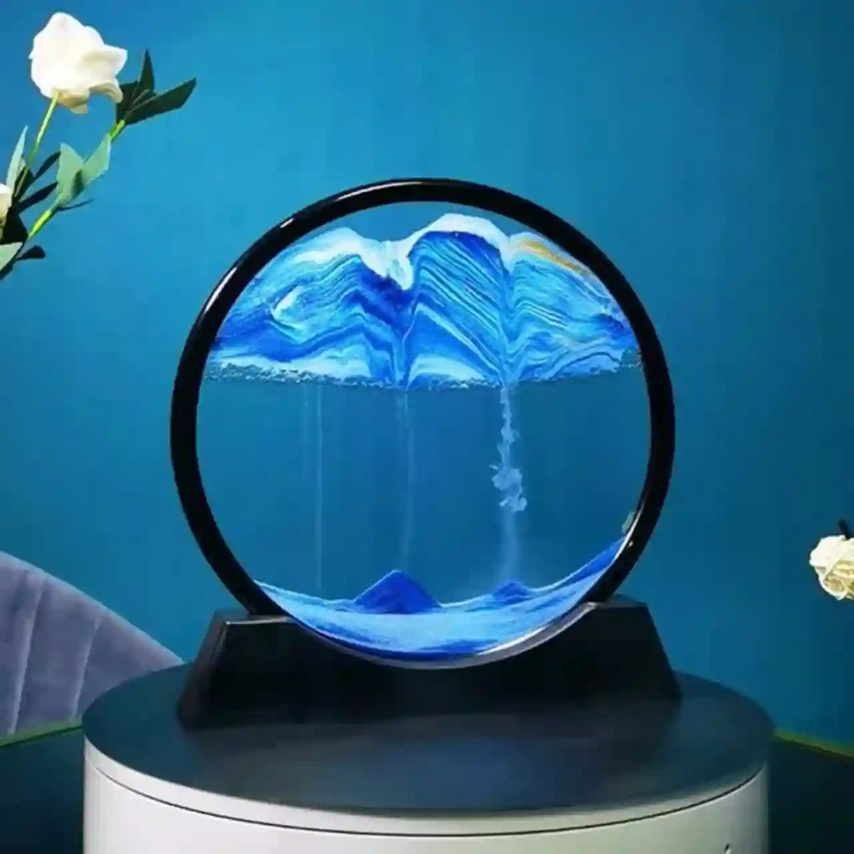 Decorative piece with blue and white design on a black stand against a blue background