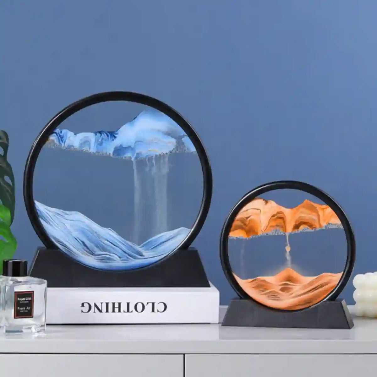 Two circular decorative items on a shelf with a blue wall background