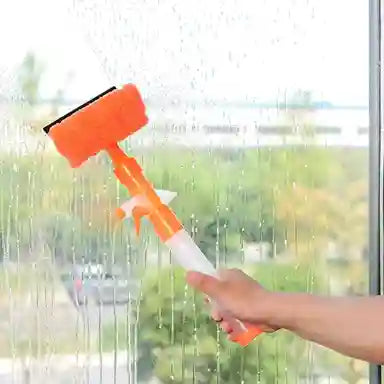 Hand using a window cleaning tool with a squeegee and spray bottle to clean a glass surface.