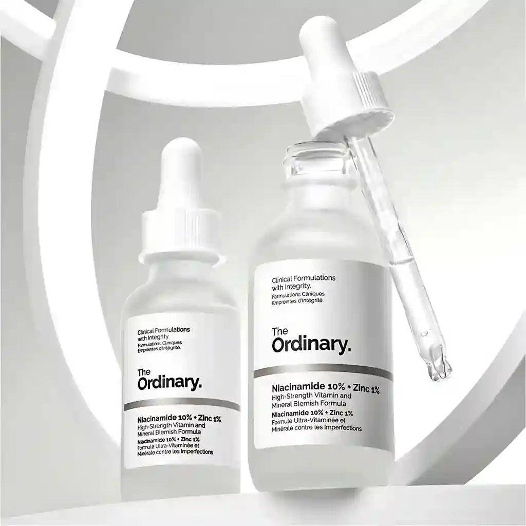 Two skincare bottles with droppers labeled 'The Ordinary' on a light gray background.