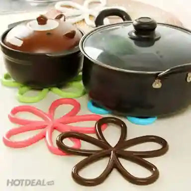 Set of colorful silicone coasters with floral designs on a white surface.