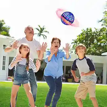 Family playing with a colorful ball in a backyard