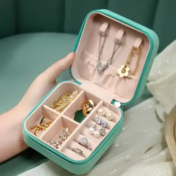 Jewelry box with necklaces, rings, and earrings on a soft surface