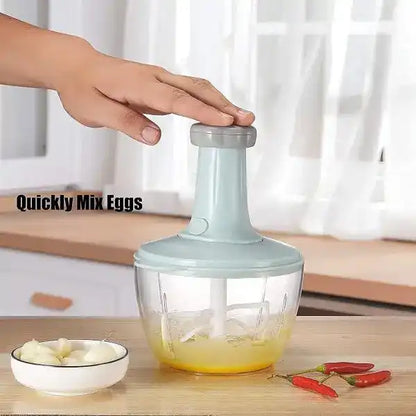 Hand using a kitchen mixer on a wooden surface with ingredients.