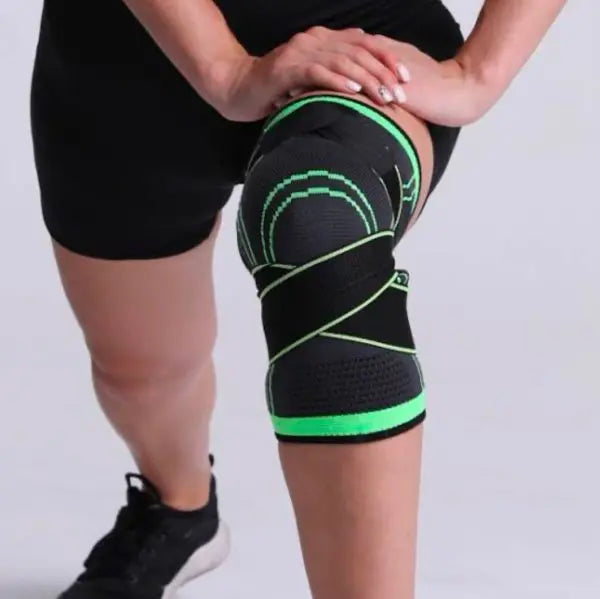 Person wearing a green and black knee brace on a plain background