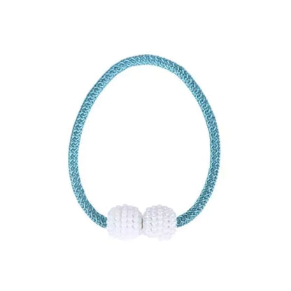 Teal hair tie with white beads on a white background