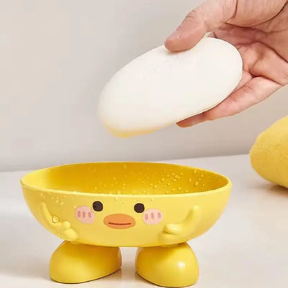 Yellow cartoon-style bowl with a face, being used to hold an egg.