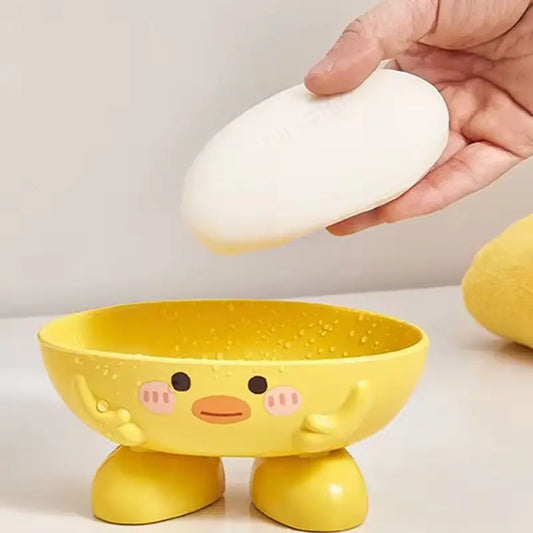 Yellow cartoon-style bowl with a face, being used to hold an egg.