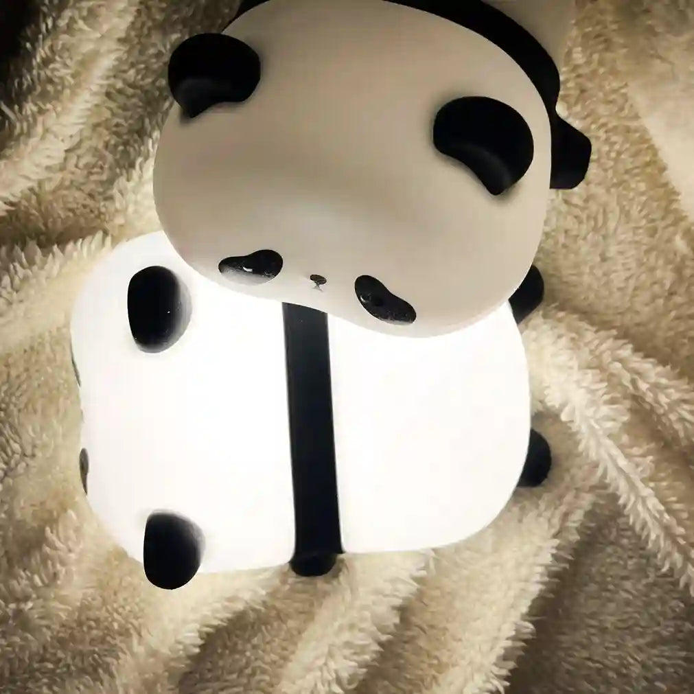 Panda-shaped night light on a soft surface