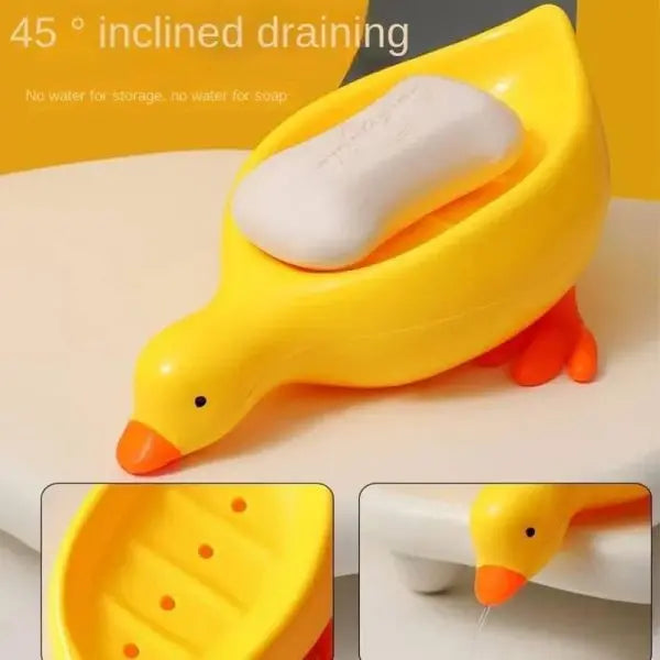 Yellow duck-shaped soap holder with a soap bar on a white surface.