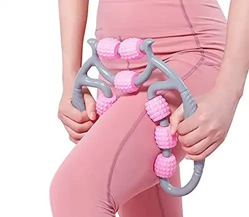 Person holding a pink and gray massage tool against a white background
