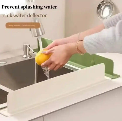 Person washing a lemon over a sink water deflector with text 'Prevent splashing water' and 'sink water deflector'.