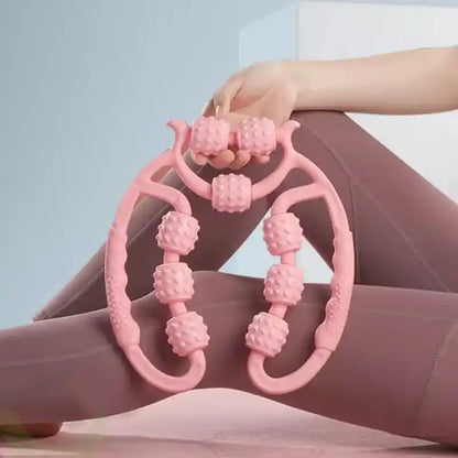 Pink foot massager being used on a foot against a light blue background