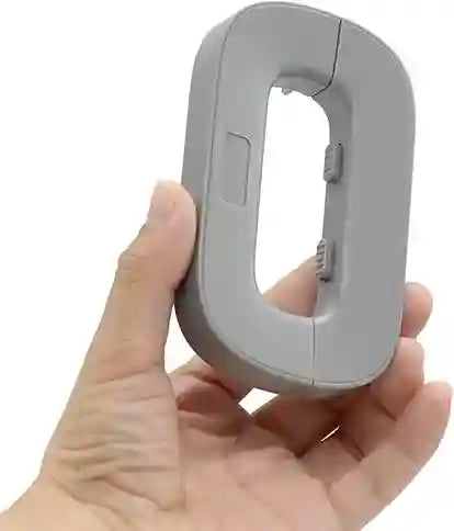 Hand holding a gray electronic device on a white background