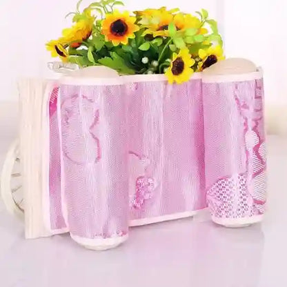 Pink lace tablecloth with floral design on a white surface with sunflowers.