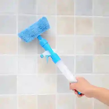 Cleaning tool with a blue and white design being used on tiled walls.