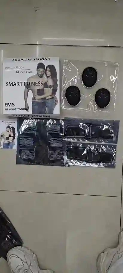 Package of smart fitness EMS devices on a white surface
