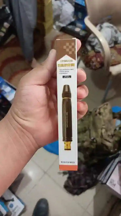 Hand holding a vape pen with packaging in an indoor setting