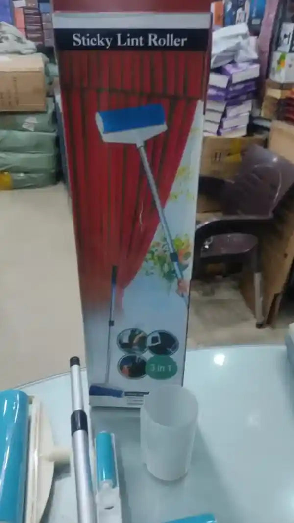 Sticky lint roller with packaging on a table in a store setting