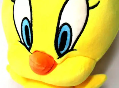 Plush toy of a yellow bird with blue eyes and an orange beak on a white background
