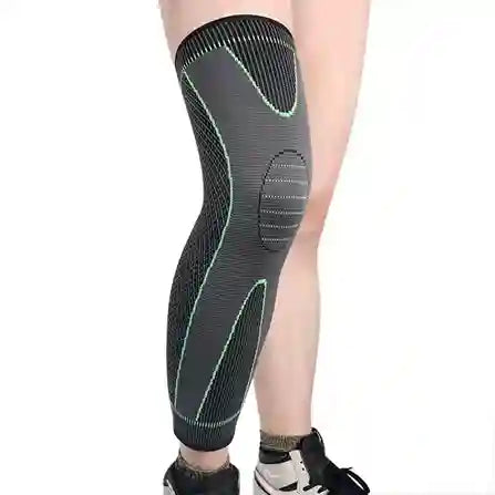 Gray knee brace on a person's leg against a white background