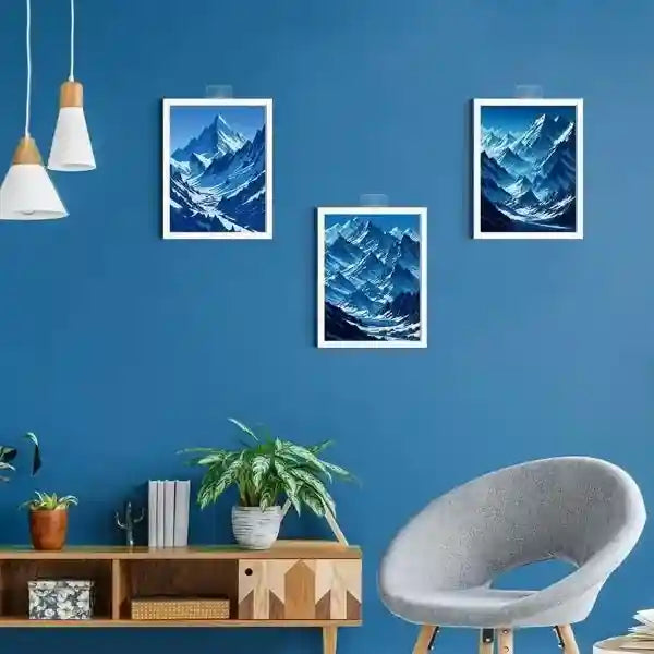 Living room with blue wall, mountain-themed artwork, and a gray chair.