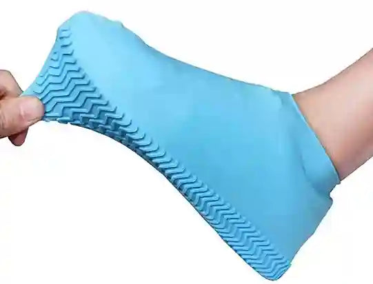 Blue silicone glove with textured surface on a white background