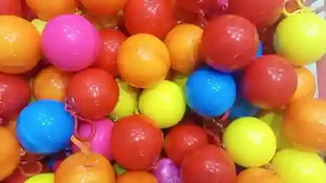 Colorful plastic balls in various colors on a white background
