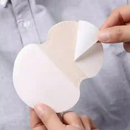 Hands holding a white silicone pad against a light gray background