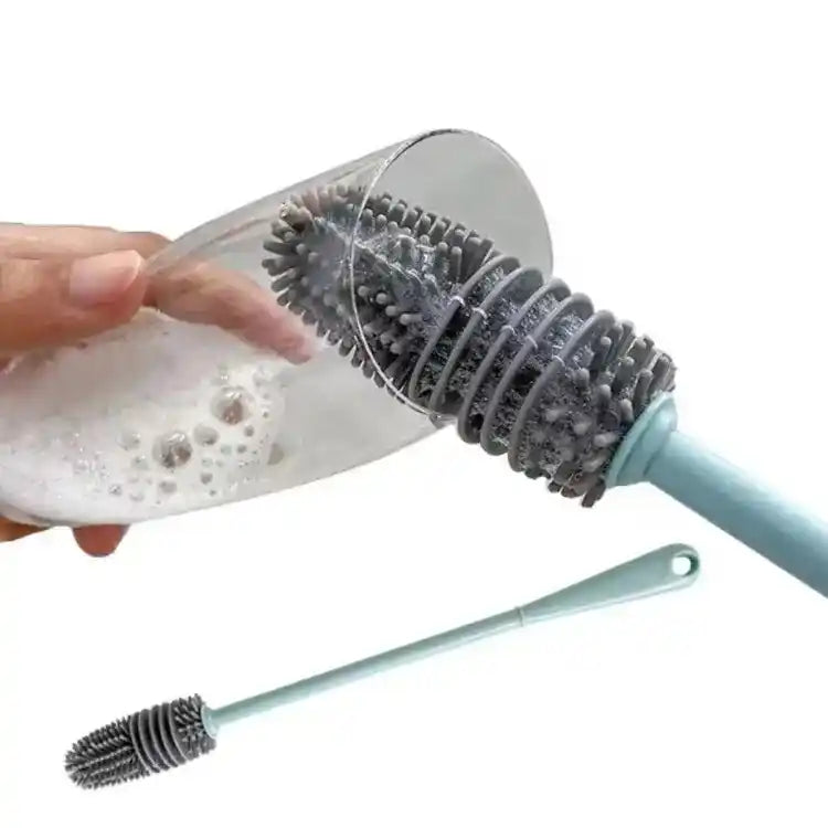 Bottle cleaning brush with a hand holding a bottle of soap and water.