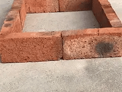 Brick foundation on a concrete surface