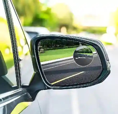 Car side mirror with raindrop on a blurred outdoor background