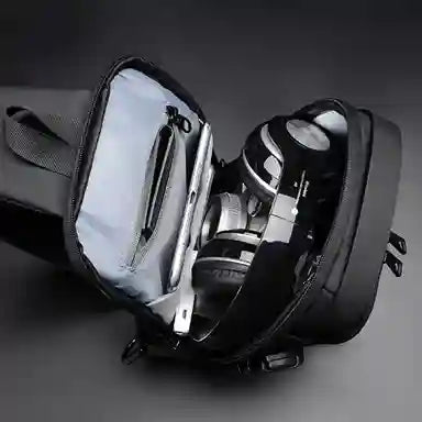 Black backpack with a shoe compartment on a dark background