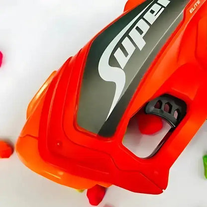 Close-up of a red and black toy gun with 'Super' branding on a white background.