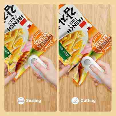 Two hands using a sealing and cutting tool on packages of French fries on a wooden surface.