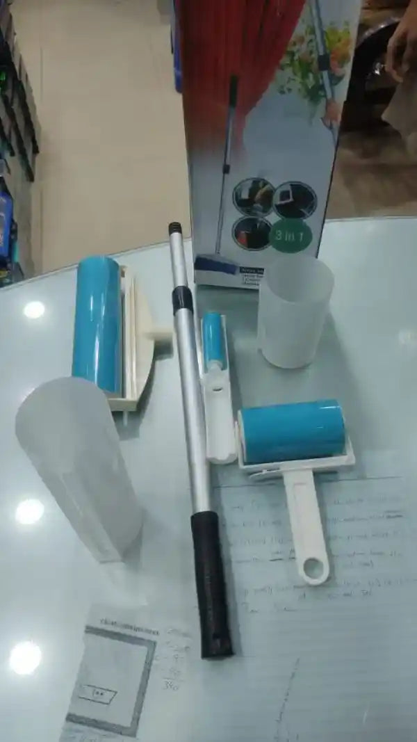 Cleaning tools including a squeegee and cleaning brush on a white surface.