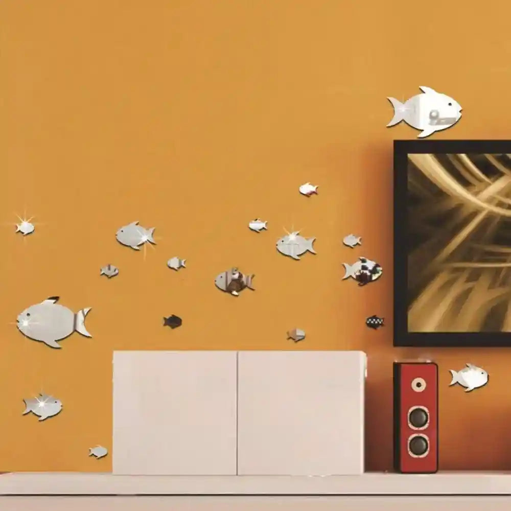 Fish-shaped wall stickers on an orange wall with a TV and entertainment unit.